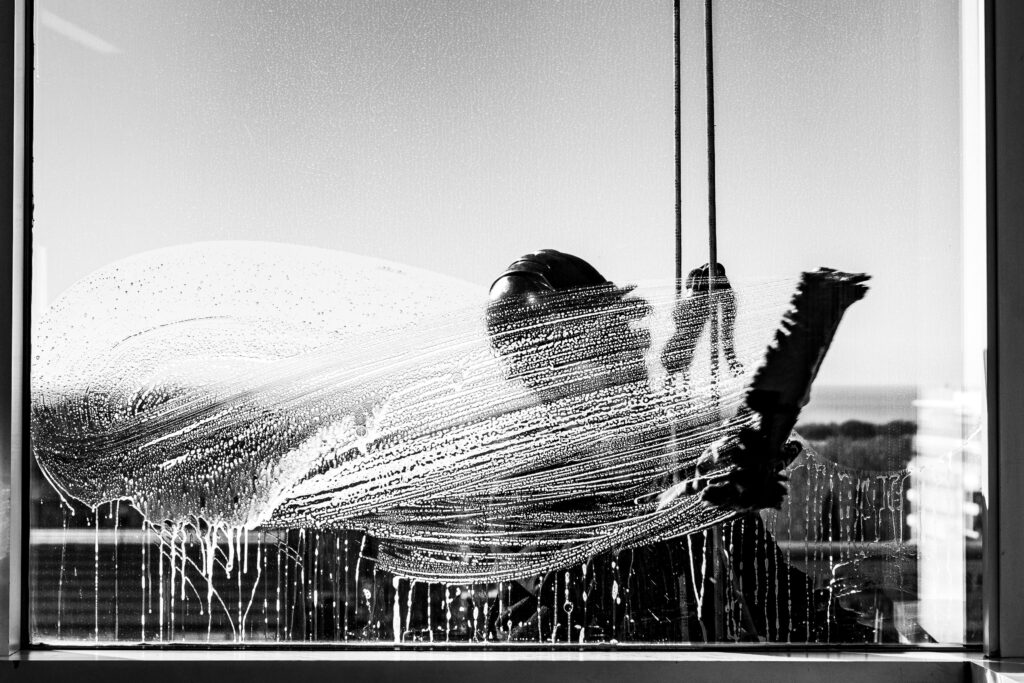 Silhouette of a window cleaner in Buenos Aires captured in black and white.