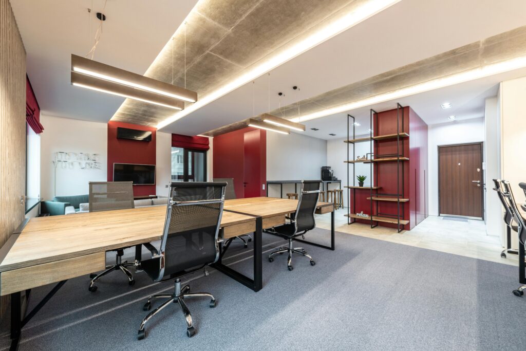 Spacious contemporary office space with wooden desks and modern decor.